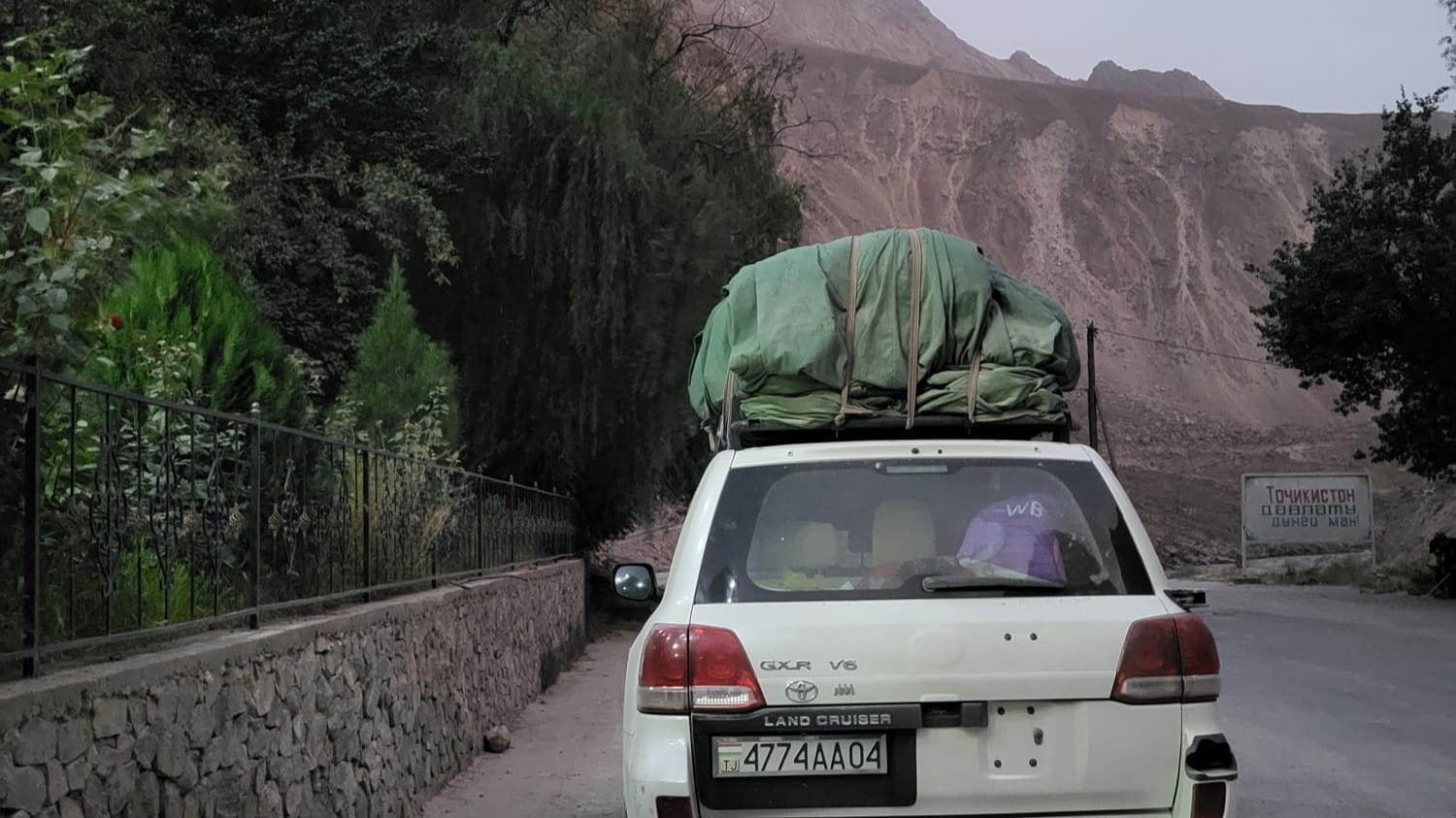 A white shared taxi in Tajikistan's Pamir Mountains.